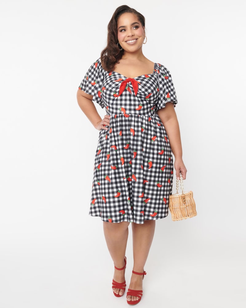 Front of a model wearing a size 4X Unique Vintage 1950s Curve Black & White Chili Pepper Gingham Swing Dress in Black/White Gingham/Chili Pepper Print by Unique Vintage. | dia_product_style_image_id:347953